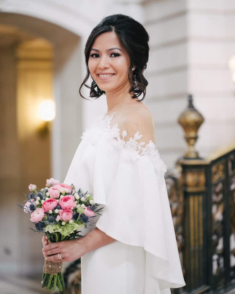 a bride holding a bouquet posing on the Grand Staircase