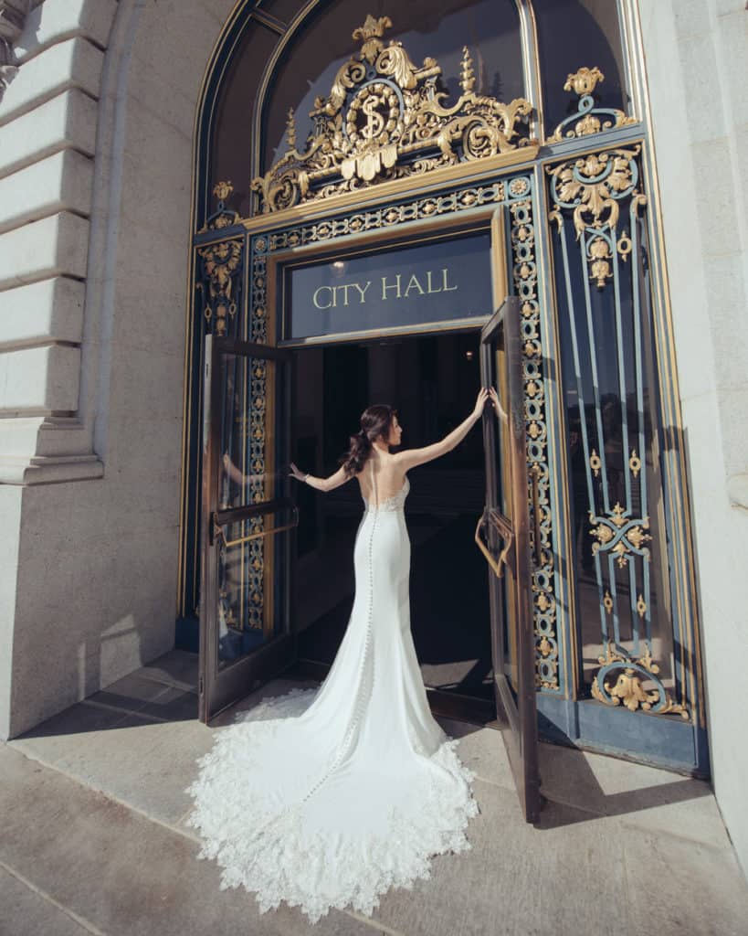a bride with a long train by the main entry