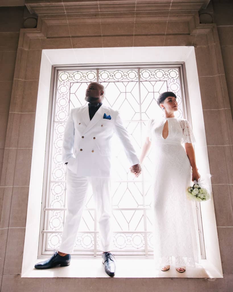 an interracial couple posing at sf city hall