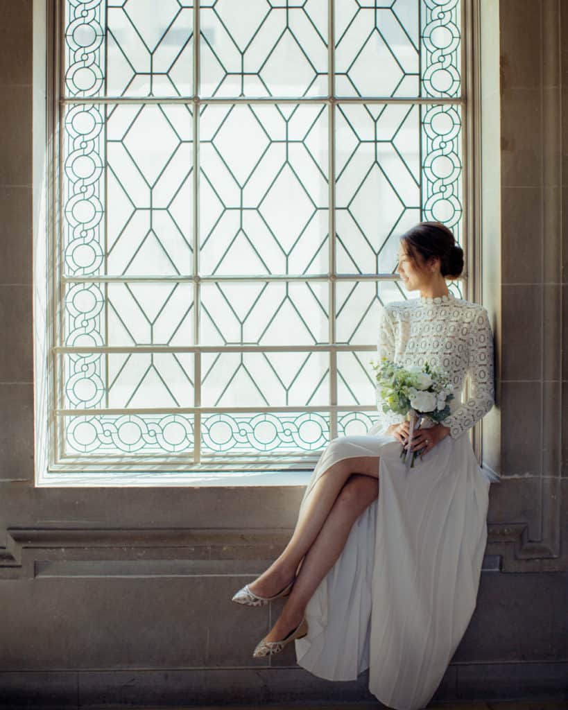 a bride sitting by the window on the 3rd floor