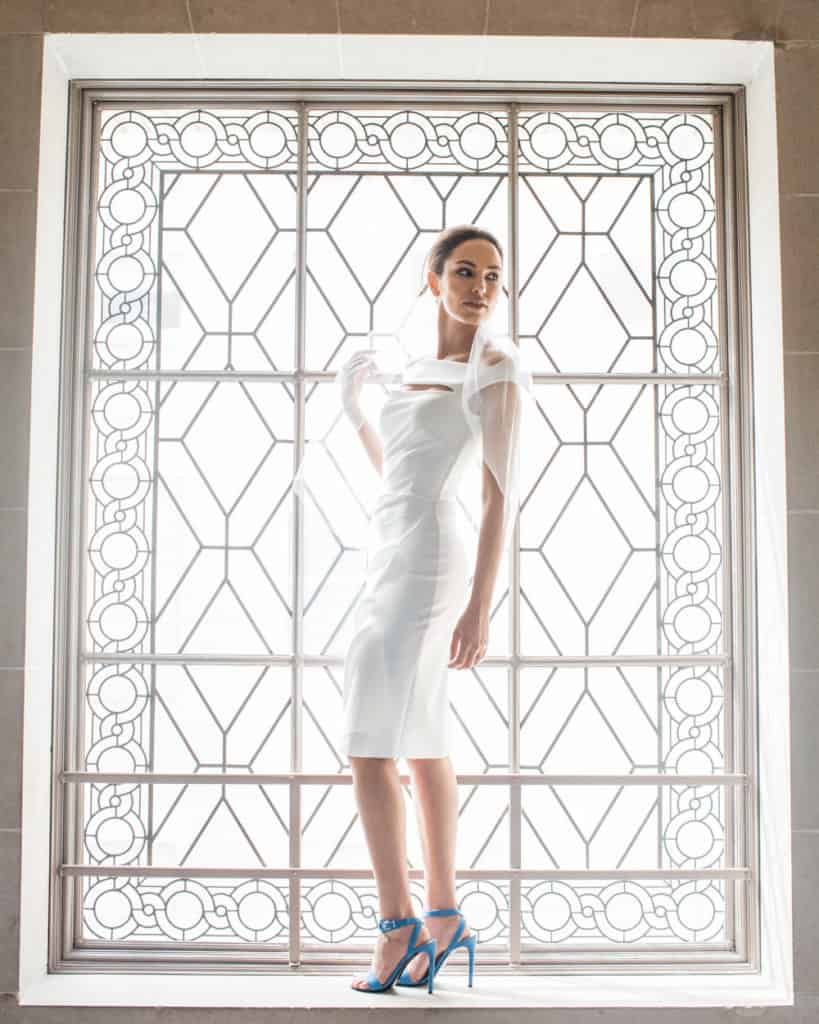 a fashionista bride posing on the 3rd froor at city hall