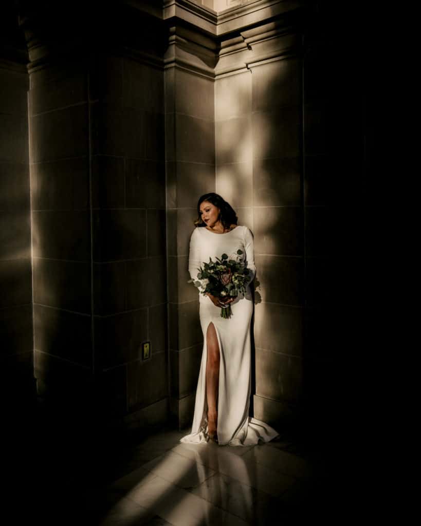 a bride standing at the sunlight on the 4th floor