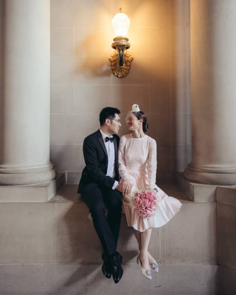 a bride in a pinkish dress with the groom near the rotunda