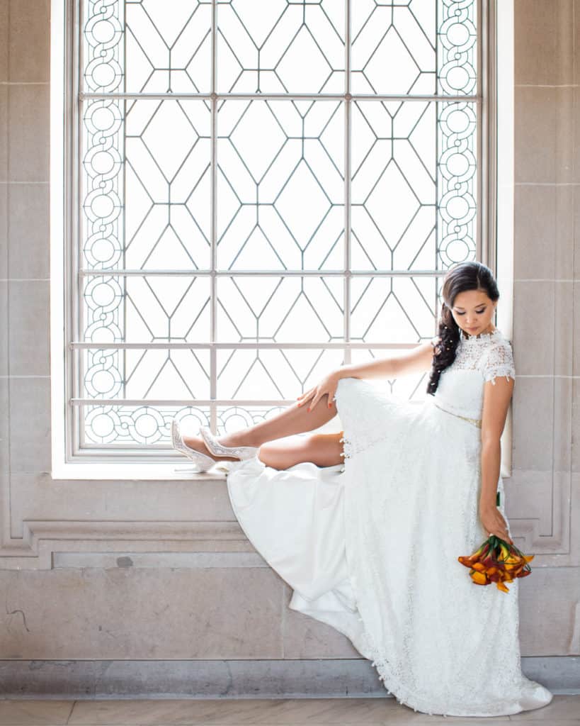a bride holding the bouquet sitting
